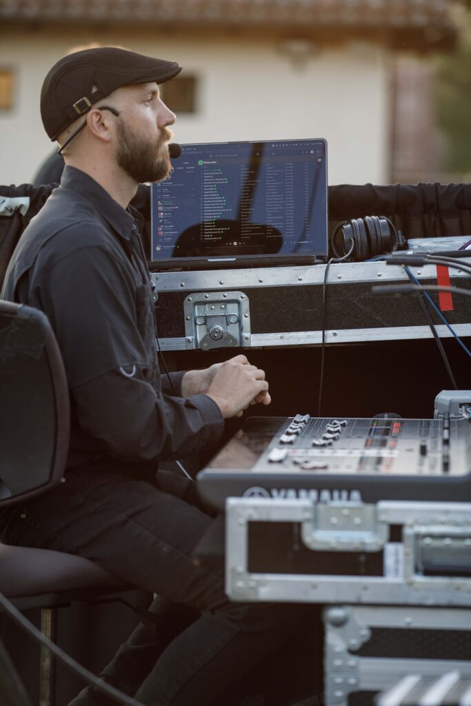man sitting with audio and visual equipment