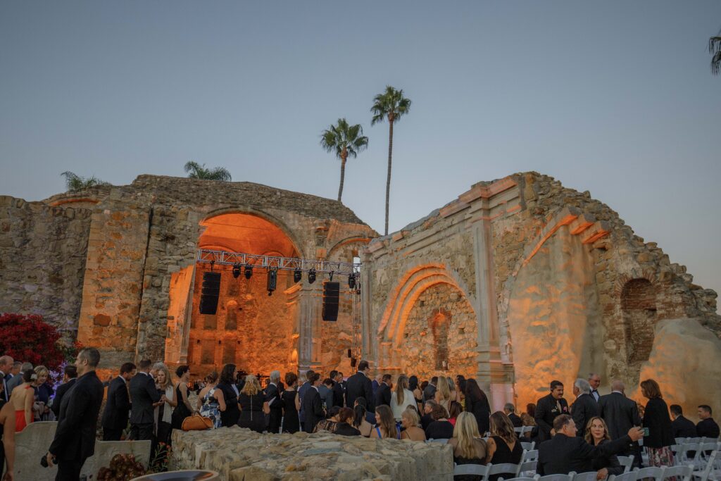 Mission San Juan Capistrano gala event with orange lighting