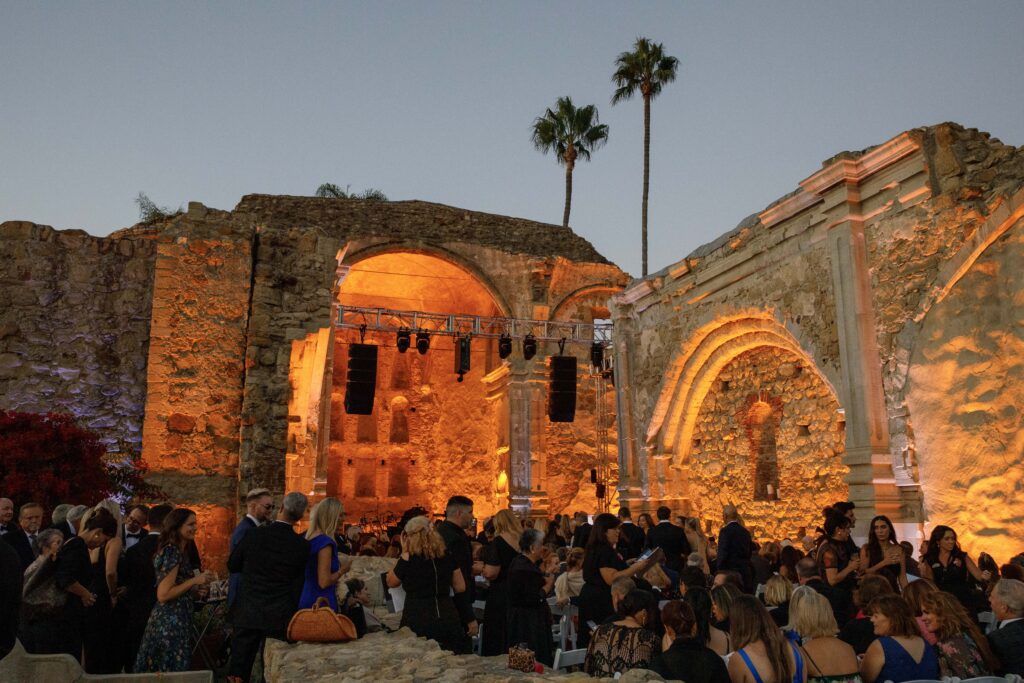 Mission San Juan Capistrano gala event with orange lighting