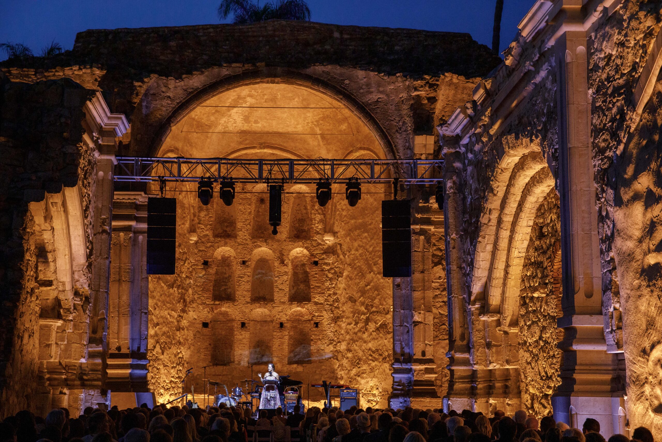 Mission San Juan Capistrano gala event with orange lighting