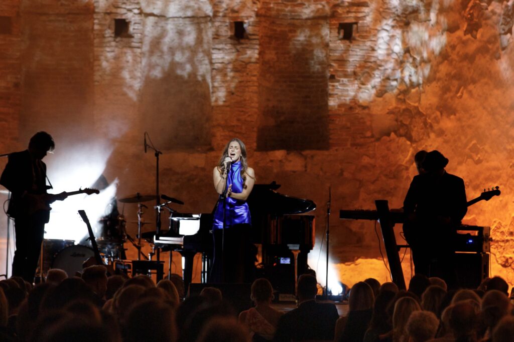 woman signs on stage 