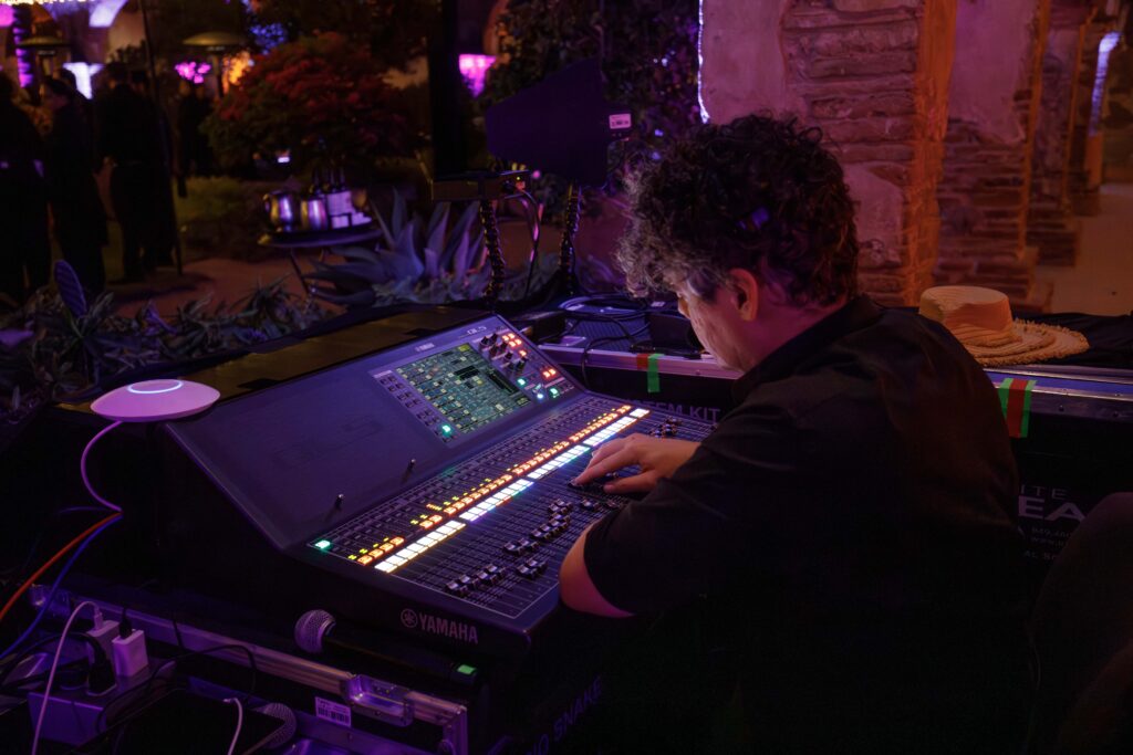 man adjusting the audio and lighting