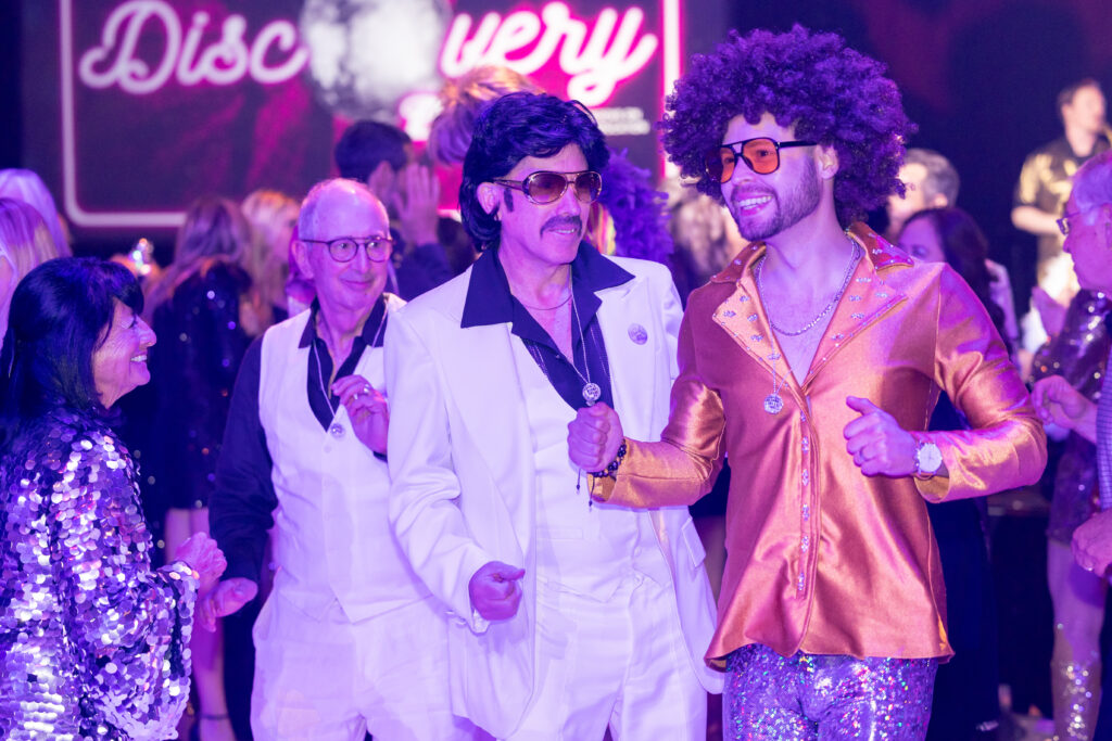 guests dressed up to fit in with the disco theme