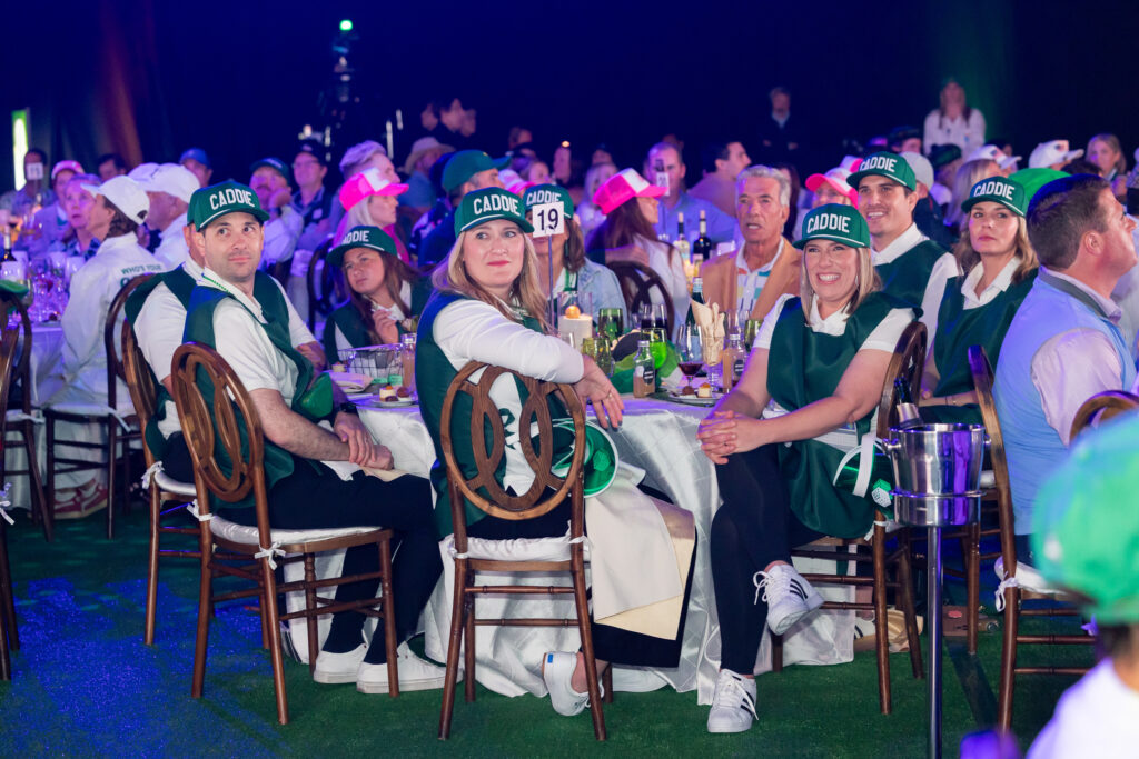 guests dressed up as caddies for the golf event theme