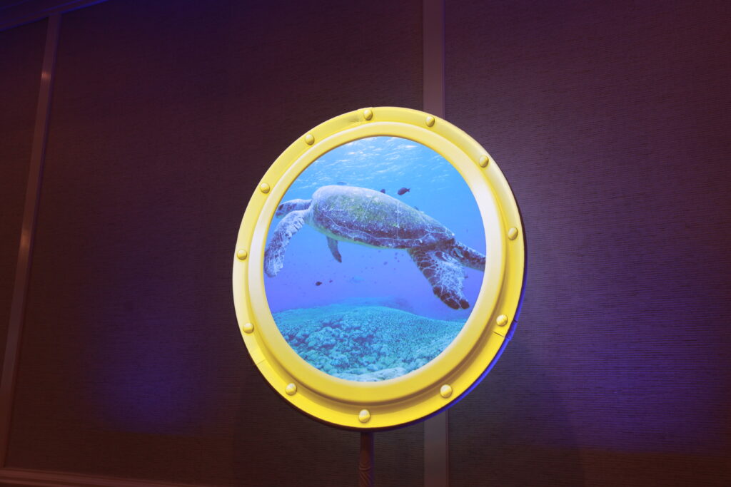 digital visual of sea creature outside of submarine window