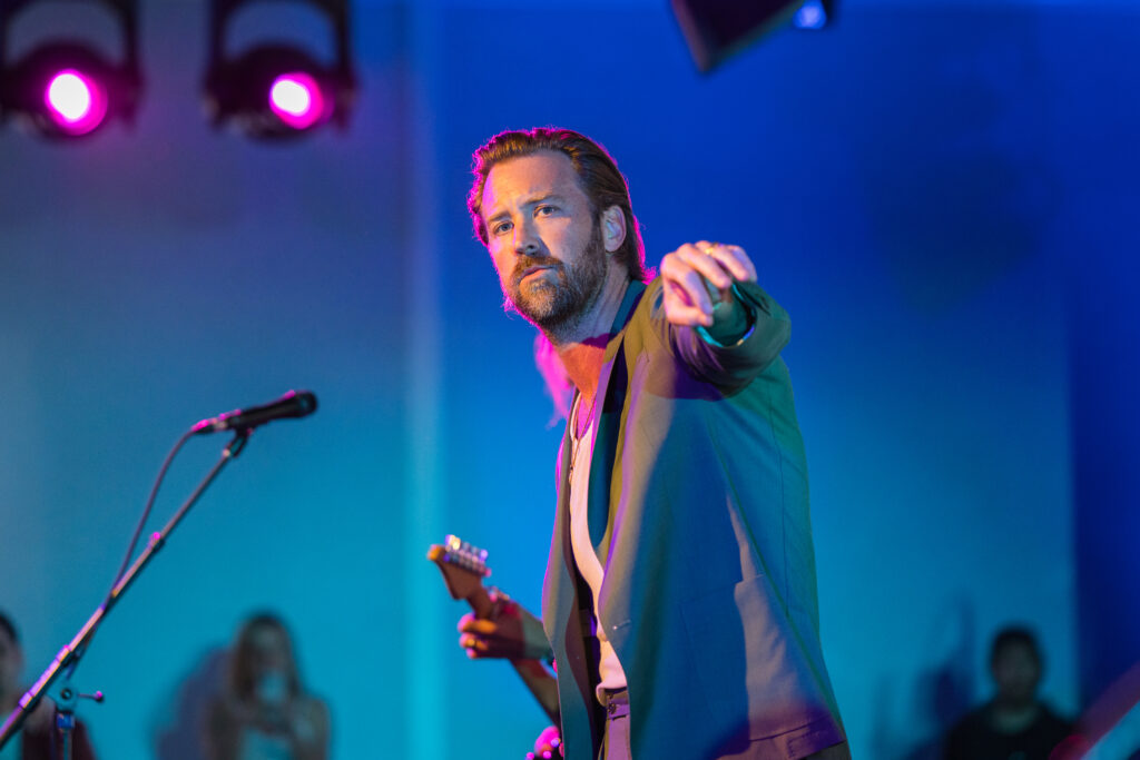 singer pointing onstage