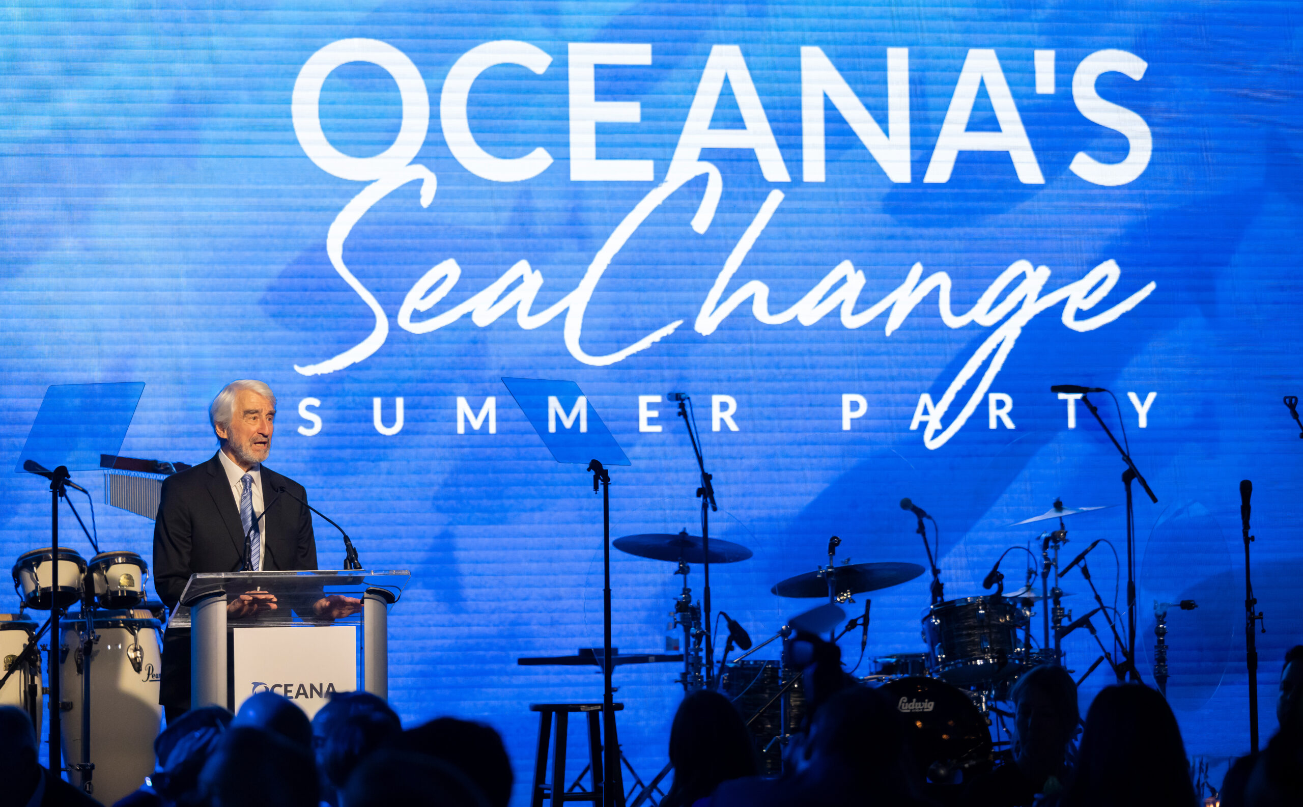 presenter with large screen for Oceana's Sea Change event
