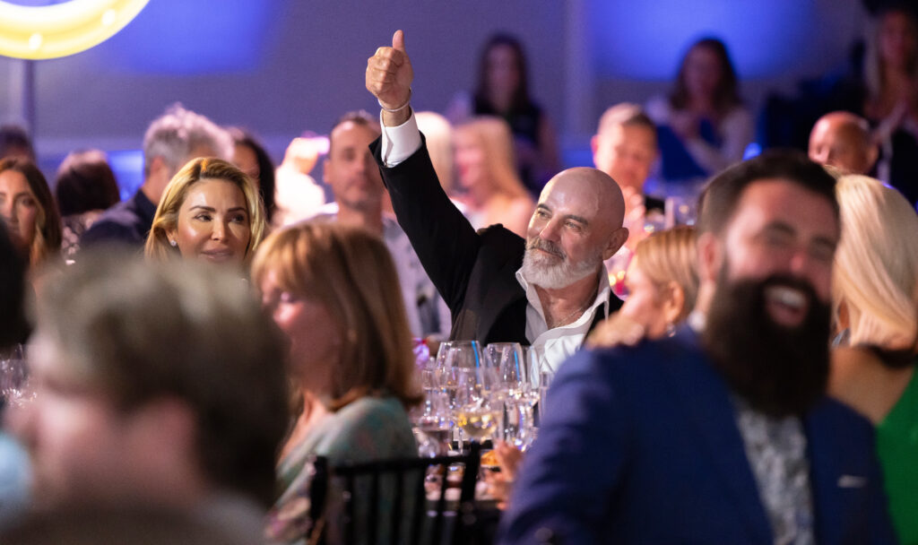 man giving thumbs up during fundraiser event