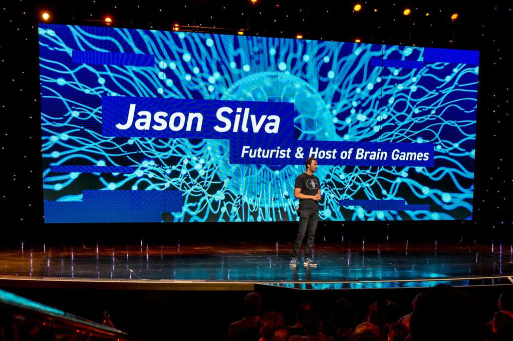 speaker speaks on stage in front of LED screen