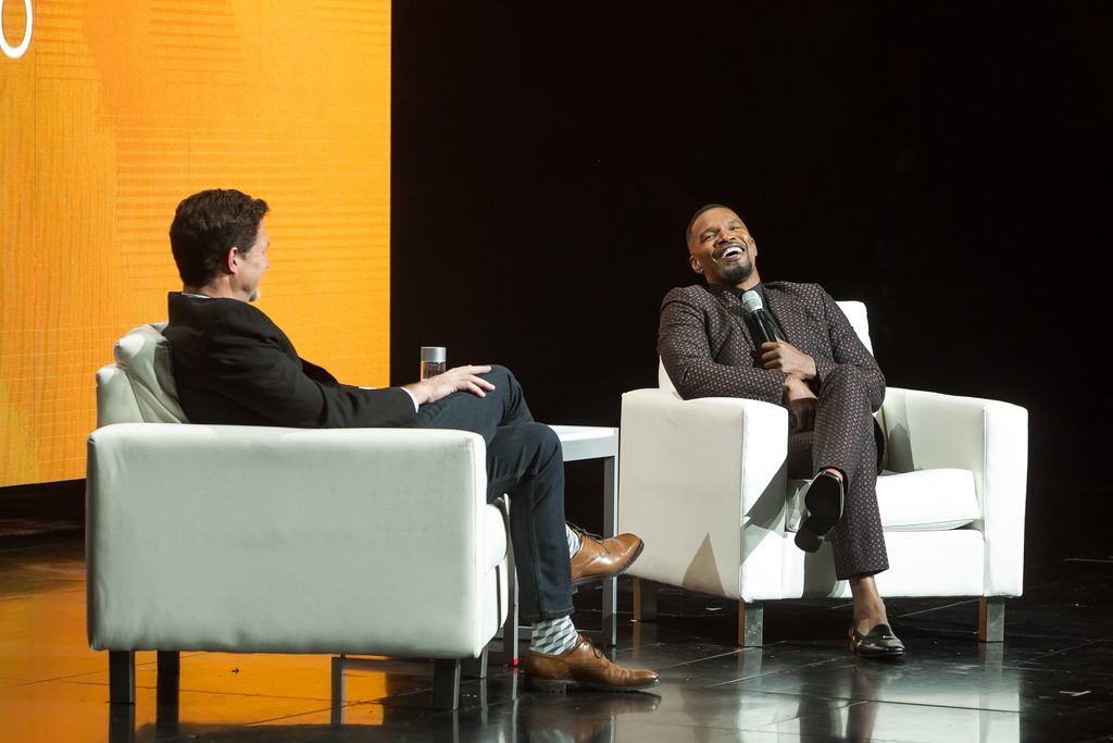 speakers sit on stage talking