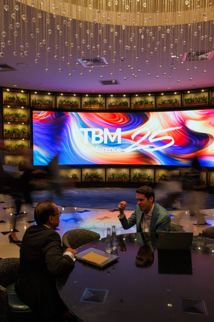 media design on screen while guests walk in 