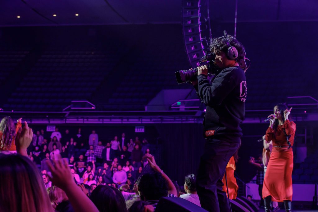 camera operator films from on stage