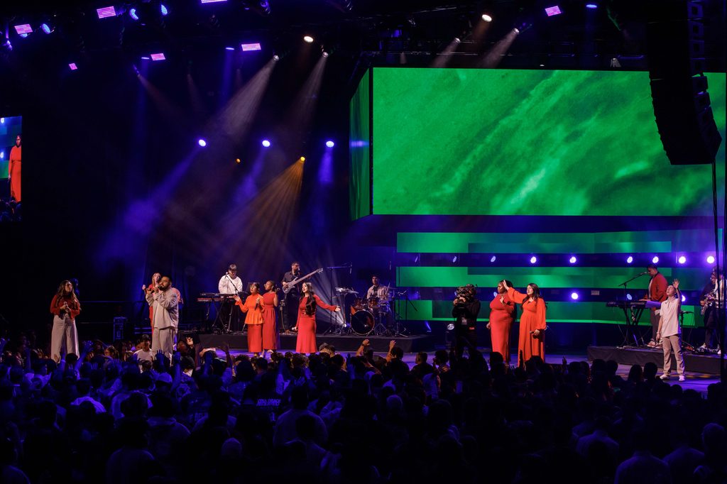 singers perform on stage with LED screen at live event